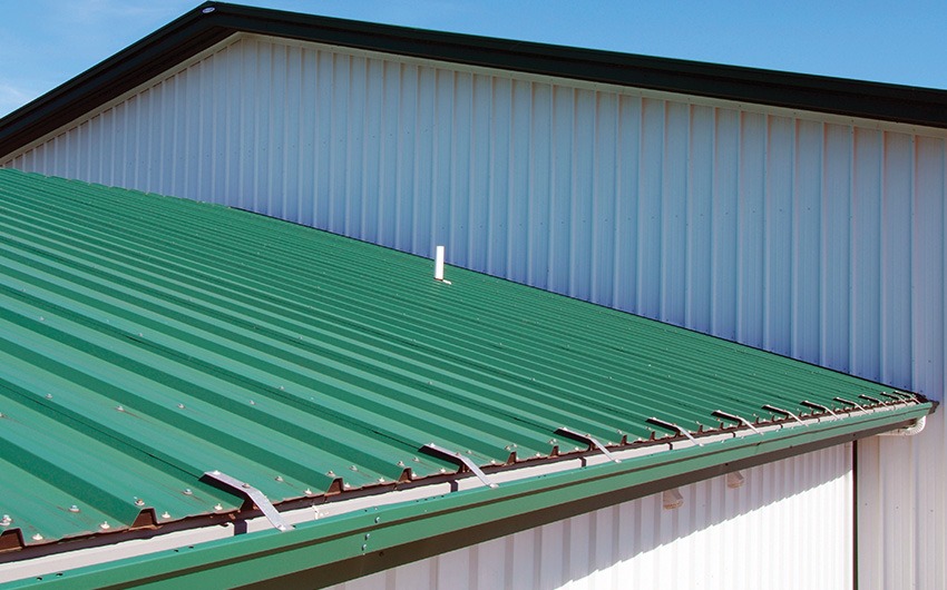 Metal roof with snow retention system installed to prevent sliding snow and ice.